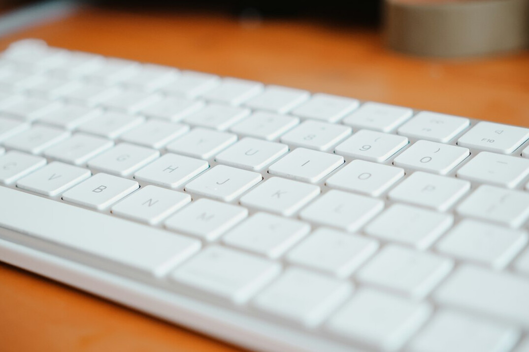 Close-up of hands typing code on a keyboard